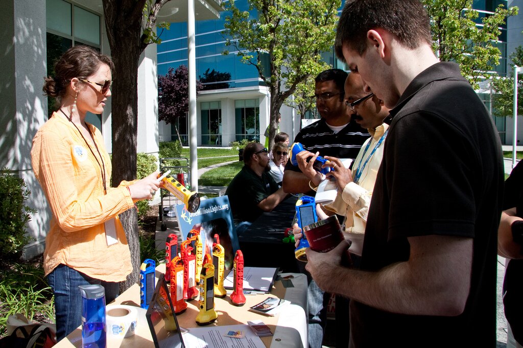 Intuit employees learn about One Million Lights solar light distributions.