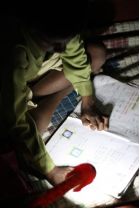 Young boy reading with his new solar light